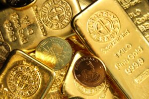 Gold bullion coins and bars representing precious metals investment